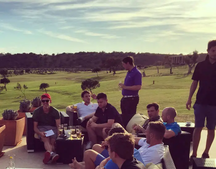 Group of golfers sat having a drink at a clubhouse in Portugal