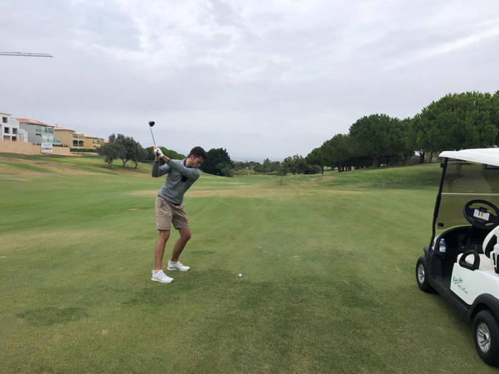 Golfer hitting a 3 wood off the deck form the fariway