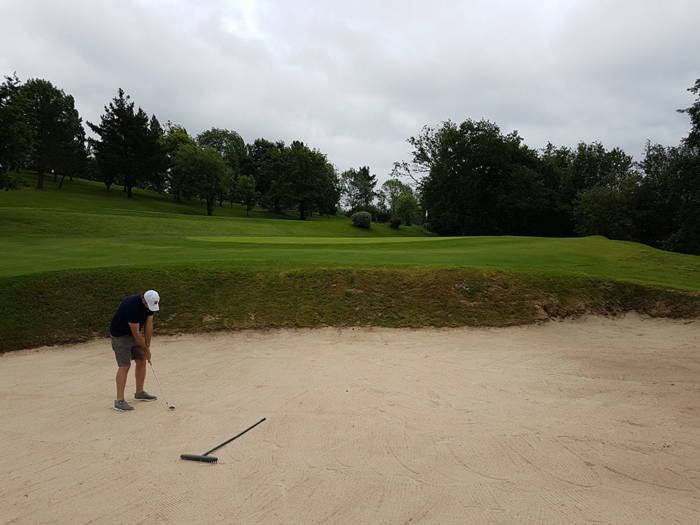 golfer hitting out of a bunker