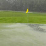 Rain flooding the green at one of the holes at TPC Sawgrass